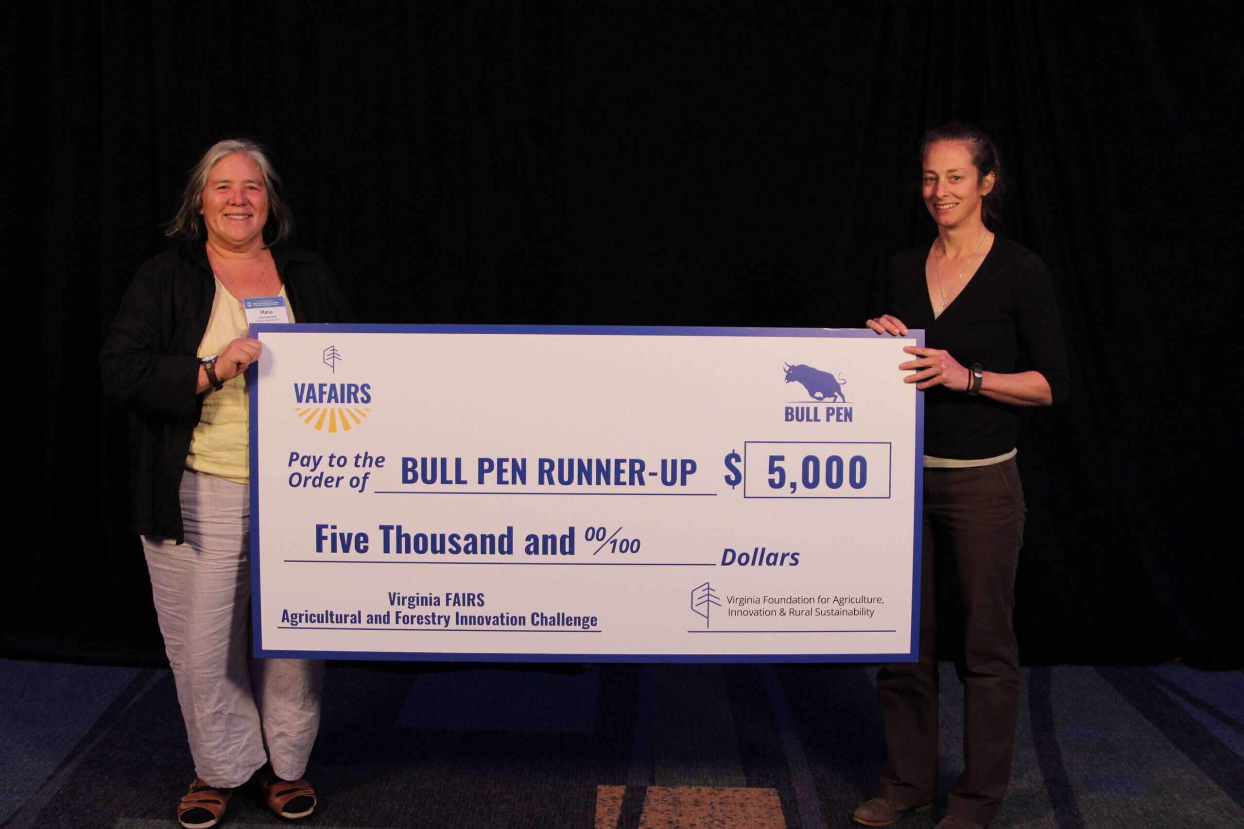 Hana Newcomb and Katherine Collins accept the $5,000 prize for being the runner-up of the 2023 Bull Pen Challenge.